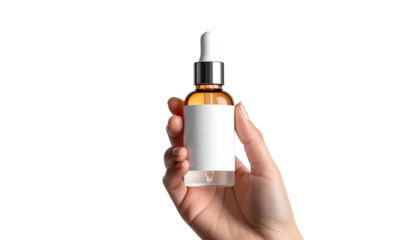 Hand holds amber bottle with dropper on a stark black background
