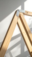 Wooden A-Frame Structure Detail with Metal Connector and Sunlight.
