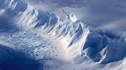 Stunning aerial view of a massive polar ice ridge and snowy mountains.