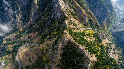 Dramatic Aerial View of Steep Mountain Ridges and Winding Roads.
