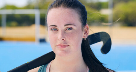 Portrait, hockey and girl on field for sports, fitness and competition outdoor with determination. Woman, athlete and player with stick for training, challenge and confidence for exercise in Canada