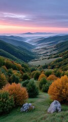 Serene mountain valley at dawn with mist rising revealing rolling hills and distant plateau under a pastel sky with soft pink and purple hues and vibrant autumn foliage in the foreground