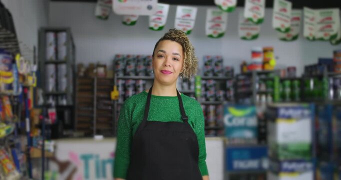 Confident woman standing in local small business hardware store, surrounded by diverse products and tools, exuding professionalism and friendliness in a vibrant retail setting
