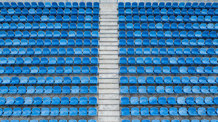 Naklejka premium Symmetrical blue stadium seats from above, a serene geometric pattern of empty spaces