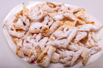 Angel wings (Faworki), cakes. Sweet pastry deep fried and sprinkled with powdered sugar