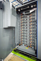 Inside a modern industrial battery energy storage system (BESS) cabinet, showing stacked power modules, advanced electrical components, and intricate wiring for grid-scale energy solutions and renewab