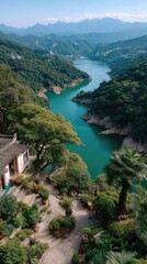 Scenic Panoramic Valley Lake With Lush Green Forested Hills Under A Clear Blue Sky And Distant Mountains With A Village View In The Foreground