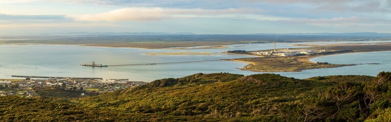 Panoramic view of Bluff, New Zealand, and the Tiwai Point Aluminium Smelter. The wharf stretching out into the harbour is the longest in the country