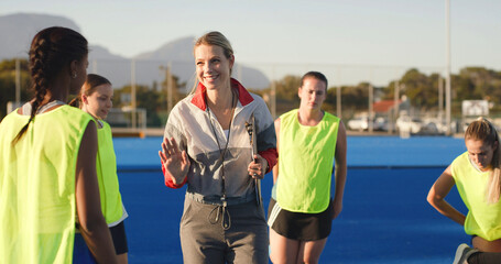 Field hockey, talking and coach with women outdoor for training, practice and match strategy. Sports hobby, fitness and people on turf with exercise for playing game, competition and tournament