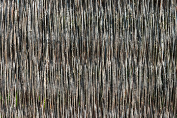 Vertical wicker twigs fence closeup background design