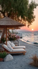 Two Empty Lounge Chairs Under a Straw Umbrella on a Pebble Beach During a Golden Sunset Over the Calm Ocean