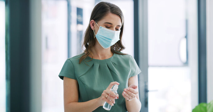 Woman, face mask and spray sanitizer in office for hygiene, disinfection and germ protection. Female person, equipment and antibacterial liquid for health safety, prevent virus and infection control