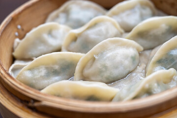 Steamed dumplings in bamboo steamer.