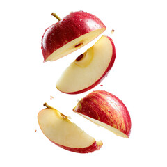 Sliced red apple segments suspended against a black background