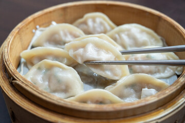 Steamed dumplings in bamboo steamer.