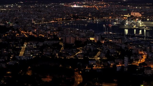 Aerial cityscape of Palma de Mallorca by night. Luminous urban landscape showing city harbor, buildings, and street lights