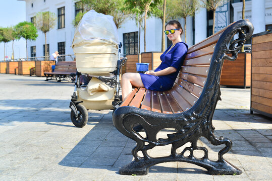 young woman sitting on bench in park