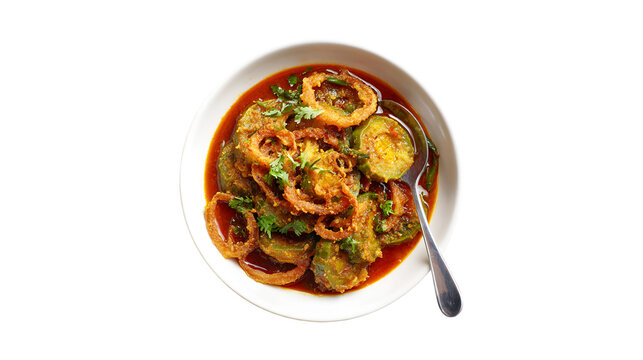 A white bowl of delicious vegetable curry topped with crispy fried onion rings and garnished with fresh cilantro served with a spoon