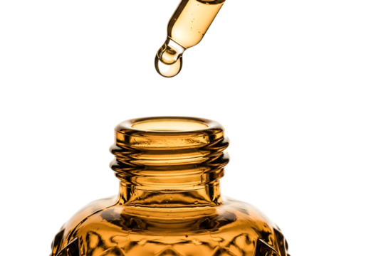 Golden amber dropper dispensing viscous liquid into a textured glass bottle isolated on transparent background