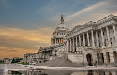 Capital Hill building in Washington DC at dawn with golden sky
