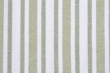 A close-up full-frame shot shows a repeating pattern of vertical stripes in muted light green and white on a woven textile surface