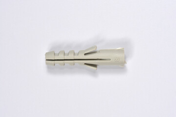 A single gray plastic wall plug size 8 is centered horizontally on a plain white background, casting a soft shadow