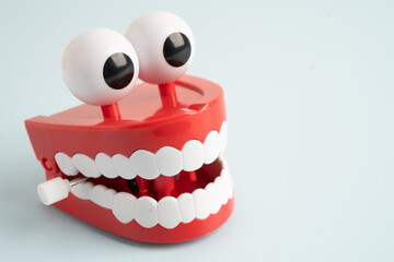 Funny red teeth with eye toy denture model for dental health care.