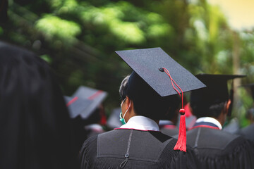 A group of people wearing black graduation gowns and caps
