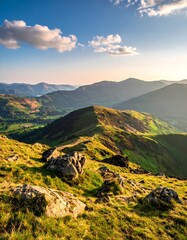 Sunny mountain range with lush green valleys and a bright blue sky