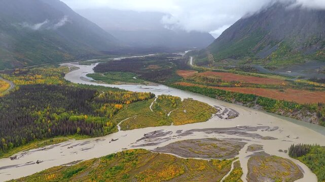 Aerial view of the Denali river valley showing the river flowing through the landscape with mountains in the background, Cantwell, Alaska, United States.