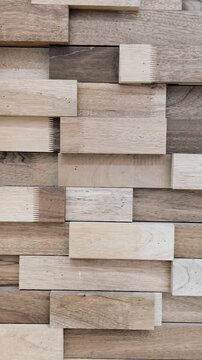 Top-to-Bottom Pan of Textured Wooden Wall Panels
Video pans vertically over staggered wooden wall panels. The varied tones and textures highlight natural grain and geometric design.