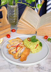 Delicious Fried Chicken and Green Rice Plated, with a vintage look, inviting to enjoy
