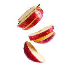 Sliced red apple segments in mid-air, isolated on black