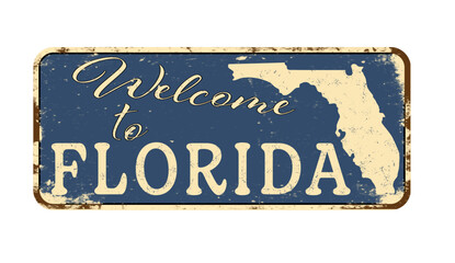 Welcome to Florida. A worn blue plaque with the name and outline of the state. Welcome inscription on the road sign