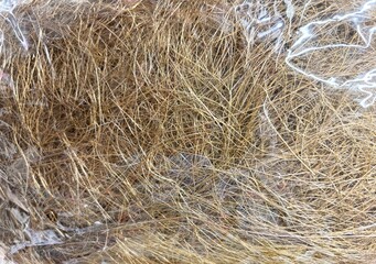 Detailed view of natural brown fiber materials in translucent packaging, rustic texture background for eco packaging or natural design themes