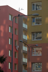 Colorful apartment buildings in a lively urban scene. Modern residential architecture showing vibrant city life and community diversity.