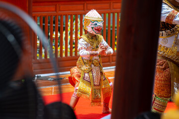 A child performer wearing a Hanuman mask in a traditional Thai Khon dance. The costume is decorated with gold embroidery, showing the beauty of Thailand's classical performing arts.