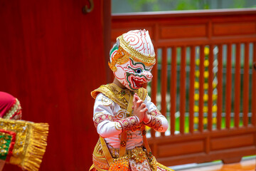A child performer wearing a Hanuman mask in a traditional Thai Khon dance. The costume is decorated with gold embroidery, showing the beauty of Thailand's classical performing arts.