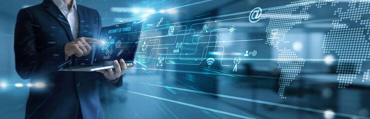 Technologist using laptop analyzing and development Internet of Things ecosystem. Smart device connectivity enabling automation, data analytics, integration, and real-time insights.