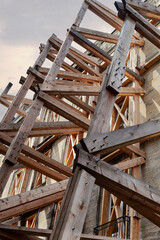 An old building is being supported because it is in danger of collapsing.