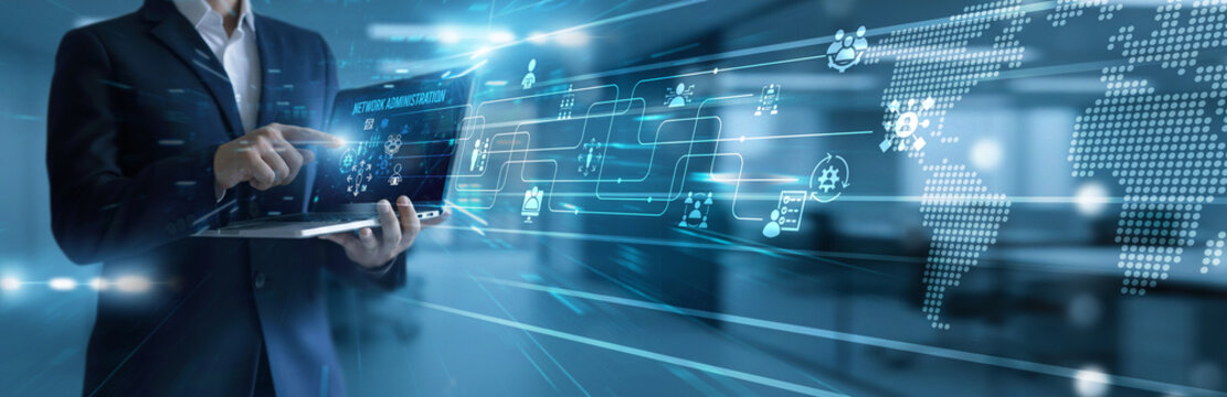 IT administrator using laptop analyzing and development network administration tools. Managing infrastructure, ensuring connectivity, performance monitoring, and system optimization.