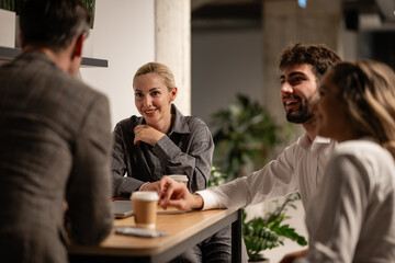 Business colleagues discussing during a coffee break in office