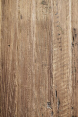 Close-up of rustic wooden planks with natural grain, knots, and weathered texture in vertical layout.