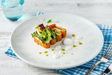 Crispy fish roulade with greens and white sauce drops