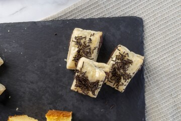 Puff pastry chocolate sprinkles dessert on slate plate