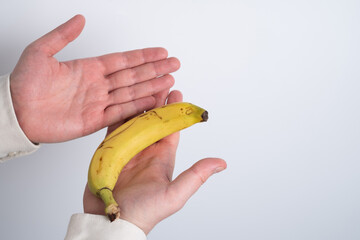 Man holding a banana. Concept: Men's health, prostate prevention, healthy eating, and vitamins.