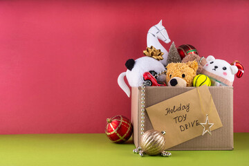 Tradition holiday toys drive, cardboard box full with with kids toys and gifts