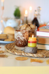 Lit candles, cookies, chocolate, nuts, tea, wine, pumpkins, books, reading glasses and autumn...