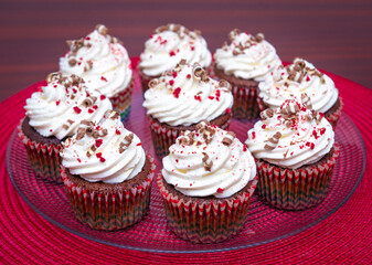 Chocolate cupcakes with cream and curly chocolate pieces