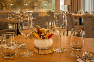 Elegant restaurant table setup with wine glasses and floral centerpiece
